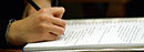 A student takes notes during a class.